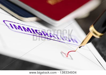 Application form close up approved fountain pen and immigration stamped on a document.