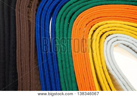 colored belts in martial arts and a part of judo uniform for an almost abstract background