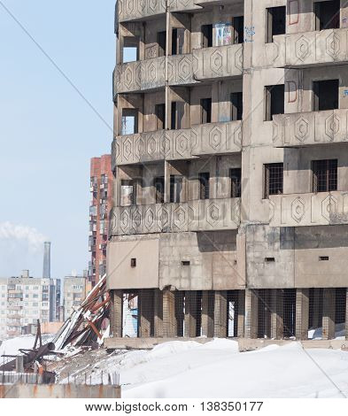 Derelict high-rise building in Norilsk. House on pile foundation, built on permafrost.