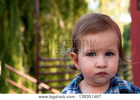A portrait of a boy outdoor using a natural light.