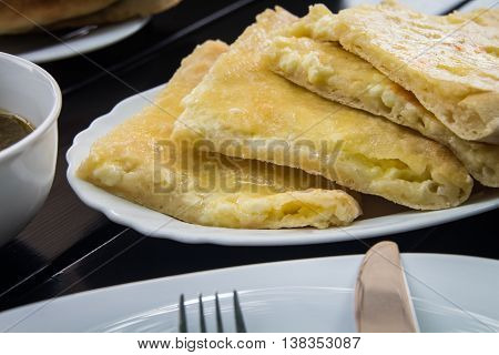 Georgian cuisine. Khachapuri near the cutlery and tea
