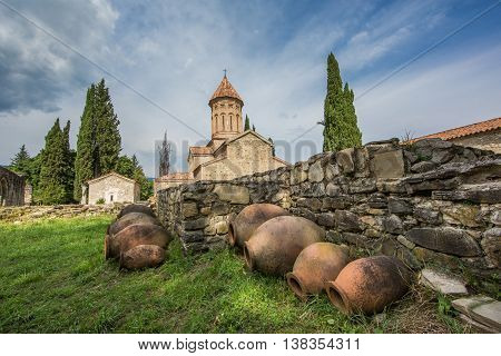 Ikaltho Monastery in rural Georgia with wine barrels in front