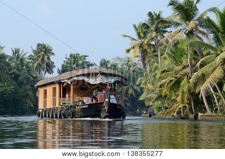 ALLEPPEY INDIA - DECEMBER 10: unidentified tourist boat at Kerala backwaters on December 10 2013 in Alleppey,Kerala,India.It's a chain of lagoons and lakes lying parallel to Malabar Coast