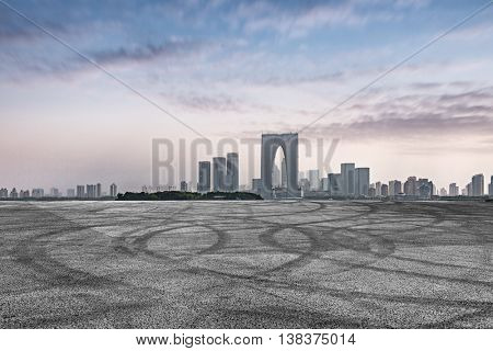 empty asphalt floor with city skyline