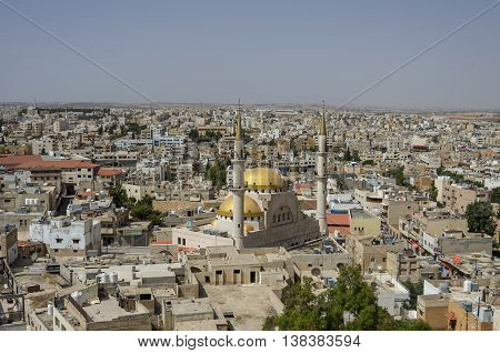 Madaba, Jordan - June 3, 2016: Panoramic view over the town center of Madaba in Jordan with the Central Mosque