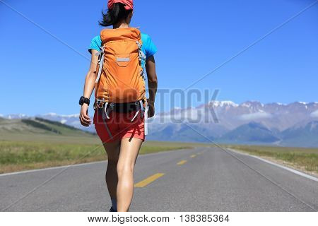young woman hiker hiking at beautiful mountain trail