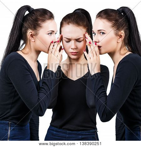 Brunette girls telling gossip to another girl with headache isolated on white