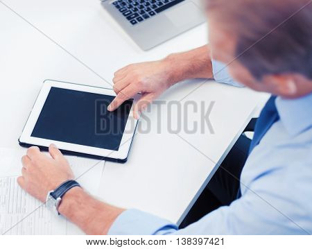 business, office, school and education concept - businessman with tablet pc in office
