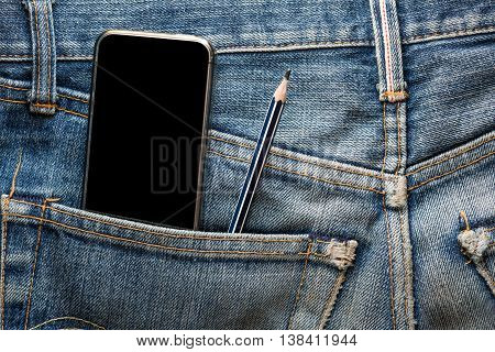 Mobile phone with pencil in back pocket faded jeans