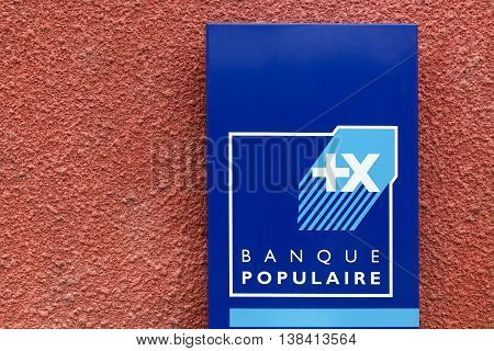 Beaujeu, France - June  20, 2016: Banque Populaire sign on a wall. Banque Populaire is a French group of cooperative banks