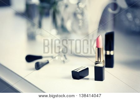Lipstick on light dressing table, close up