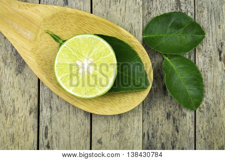 lime slice and leaf on wood padle