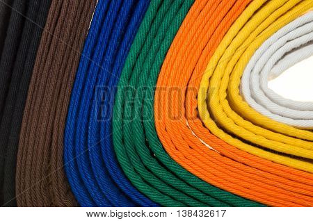 colored belts in martial arts and a part of judo uniform for an almost abstract background