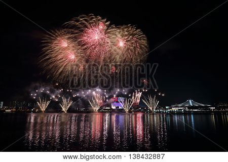 Fireworks celebrating Singapore's National Day across Kallang River