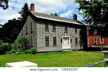 Hancock New Hampshire - July 11 2013: 18th century New England wooden saltbox home with dual chimneys and plain windows
