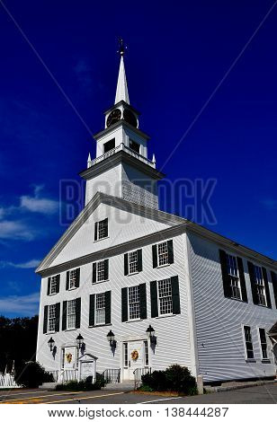 Rindge New Hampshire - July 12 2013: White wooden colonial 1796 Second Rindge Meeting House and Town Hall overlooking the Village Green