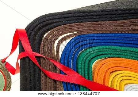 colored belts in martial arts and a part of judo uniform and medal