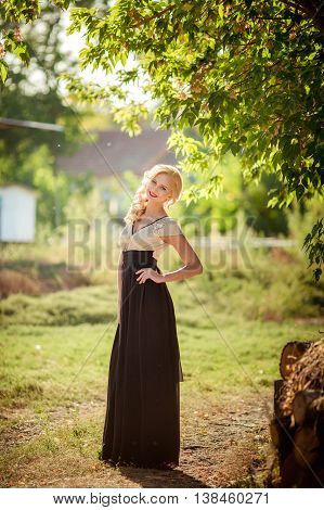 Photo of beautiful blonde girl in summer garden