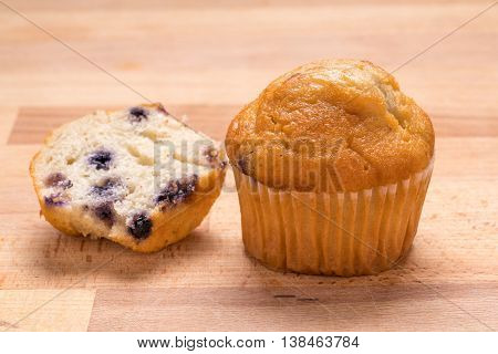 Tasty Blueberry muffins on a Wood Background