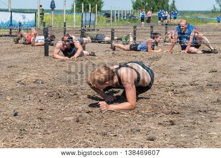 Tyumen, Russia - July 9, 2016: Steel Character extrim race on Voronino Hill. Army Test. People jumping, crawling, passing under a barbed wires or climbing obstacles during extreme obstacle race