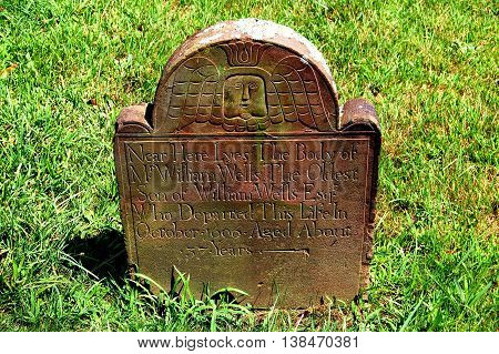Southold New York - August 15 2009: Colonial tombstone dating to 1696 with winged angel inthe 1803 Southold Presbyterian Church cemetery