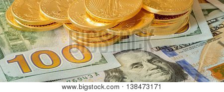 Gold Coins Stacked On New Design 100 Dollar Bills