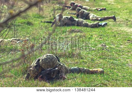 Military soldiers at tactical exercises with guns