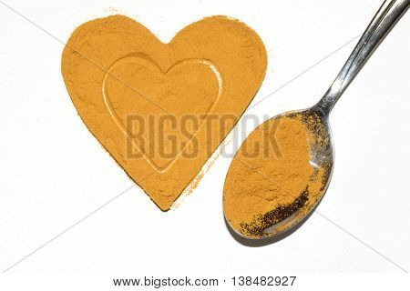 Turmeric heart health yellow spice powder on white background
