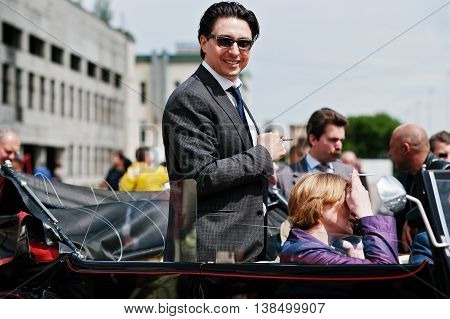 Podol, Ukraine - May 19, 2016: Elegant Man On Sunglasses Ray Ban With Cigarette Stay And Smile On Ma