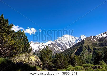 snow mountains with green hills and blue sky, landscape