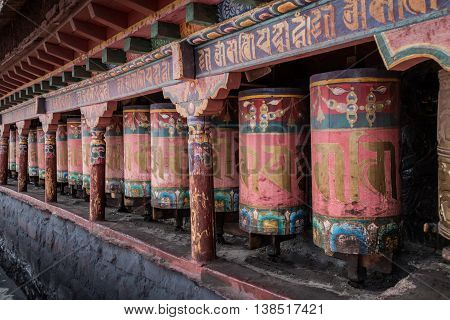 Kora Prayer wheels installed in Tibetan temple.