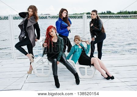 Five Beautiful Young Girls Models At Leather Jackets Posing On Berth.