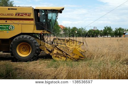 TRNOVEC, CROATIA - JULY 09, 2016: Combine harvester harvest ripe wheat on a farm in Trnovec, Croatia on July 09, 2016