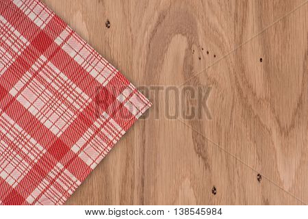the checkered tablecloth on wooden table. the checkered tablecloth on wooden table.