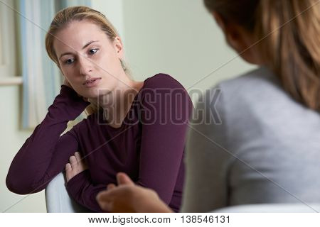 Unhappy Young Woman Discussing Problems With Counselor