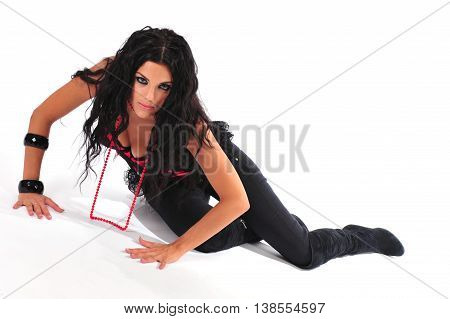 Sexy brunette in red corset with long hair spreading out lying down on a floor