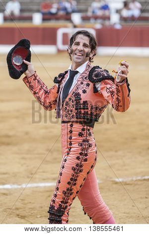 Andujar Spain - September 23 2011: The Spanish Bullfighter Juan Jose Padilla greeting the public with its cap in the hand in gratitude to its bullfight in the Bullring of Andujar Spain