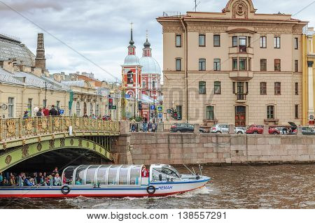 SAINT PETERSBURG, RUSSIA -JULY 09, 2016: Tourist boat floats under Panteleimon bridge on the river Fontanka in the historic center of St. Petersburg