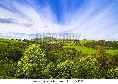 Landscape Scenery Of Green Valley, Hill And Cloudy Blue Sky