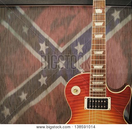 Southern Rock concept - detail close up of a guitar leaning against an amplifier with confederate rebel flag - vintage instagram filter applied