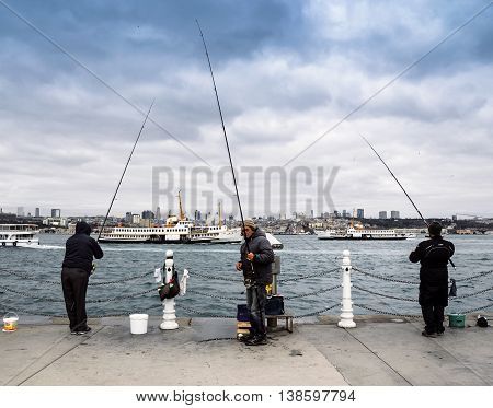 Istanbul Turkey - December 4 2013: Bosphorus Fishing Istanbul. Istanbul Asian side of the photo seen people fishing in the Uskudar district. In Istanbul particularly the differences in temperature and salinity between the Black Sea and the Mediterranean m