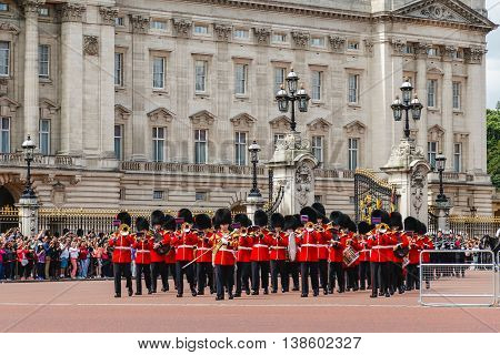 LONDON UK - 28TH JUNE 2016: Musical support from the Regimental Band during the Changing of the Guard ceremony at Buckingham Palace in the summer. The soldiers can be seen wearing scarlet tunics and bearskin caps