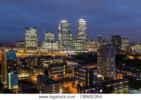 LONDON UK - 28TH JUNE 2016: A view towards Canary Wharf at night. Apartment buildings can be seen in the foreground.