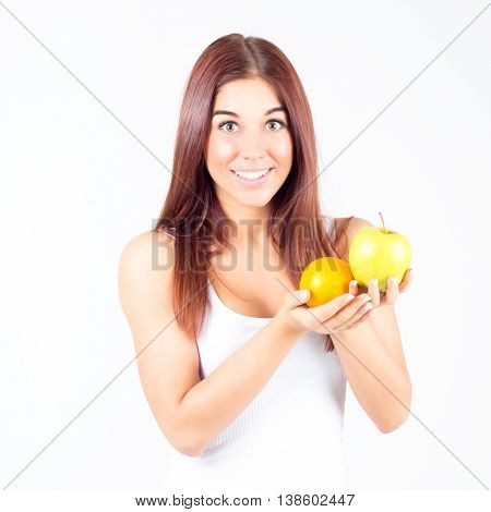 Happy smilling woman with orange and apple in hands. Healthy lifestyle.