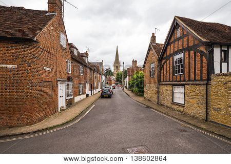 BUCKINGHAM UK - 4TH JULY 2016: A view along streets in the old part of Buckingham Town during the day. The outside of buildings can be seen.