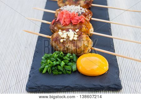 Tsukune Japanese chicken meatballs with scallimons and yolk