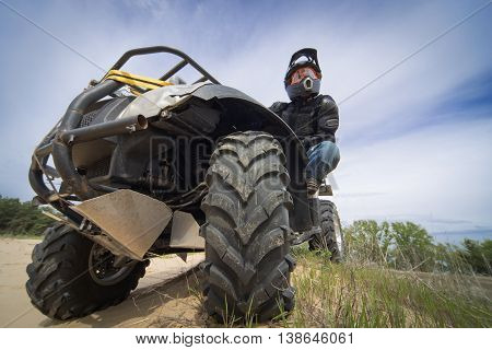 Racing ATV on the sand in summertime.