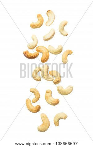 Cashew nuts falling on white background .