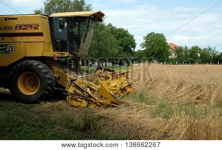 TRNOVEC, CROATIA - JULY 09, 2016: Combine harvester harvest ripe wheat on a farm in Trnovec, Croatia on July 09, 2016