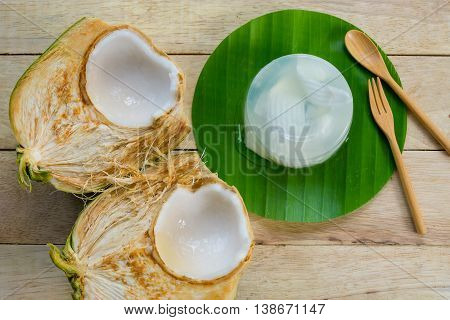 coconut jelly and wooden spoon on wooden background